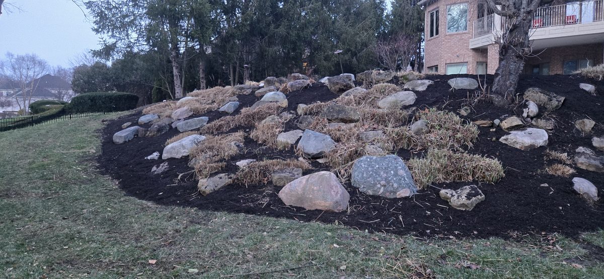 Large boulder retaining wall installation