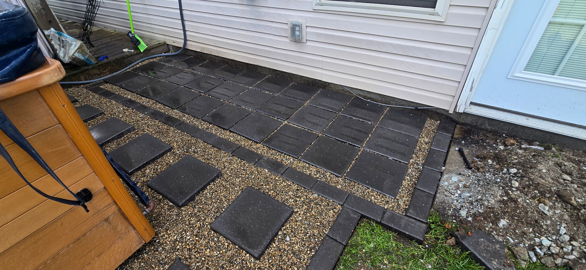 Dark paver patio installation
